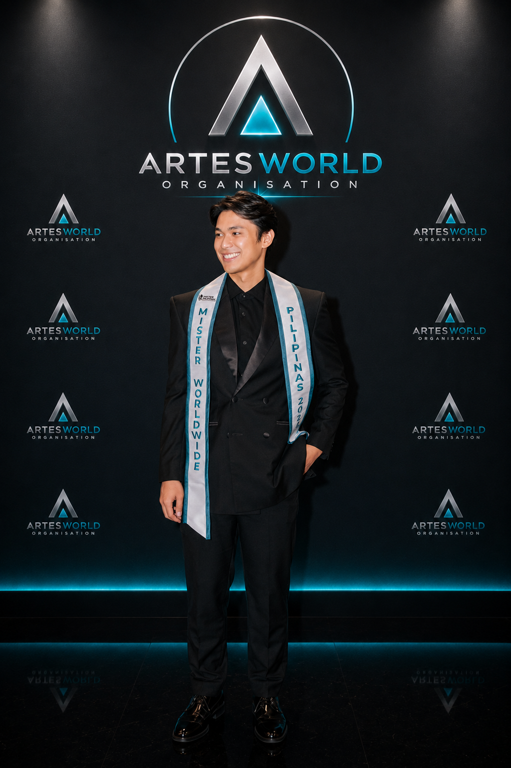 ChatGPT Image May 17 2026 01_00_39 PM Man wearing a sash that says "Mister Philippines Worldwide" poses for a photo.